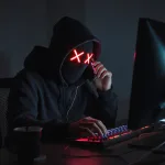 A computer hacking talking on a cellphone