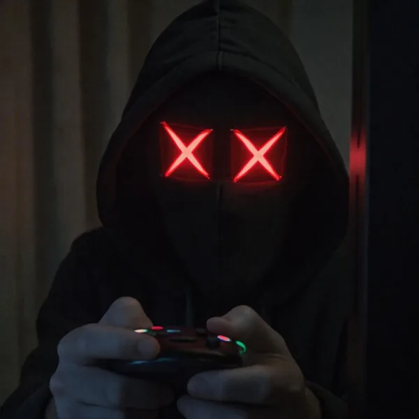 Computer hacker holding a video game controller