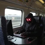 hacker riding on a subway train