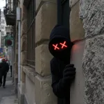 hacking hiding peaking from behind a wall