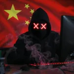 Computer hacker in front of a Chinese flag